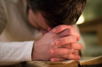 man-with-head-bowed-in-prayer